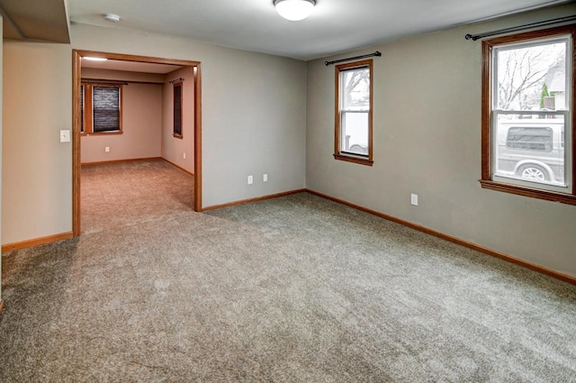 spare room featuring light carpet and a healthy amount of sunlight