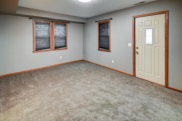 view of carpeted foyer entrance