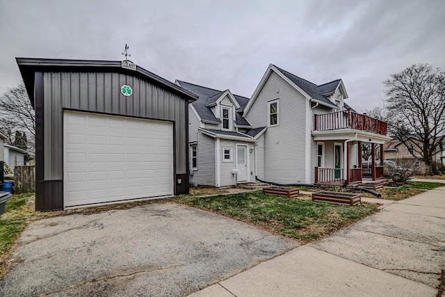 view of front facade featuring a balcony, covered porch, and a garage