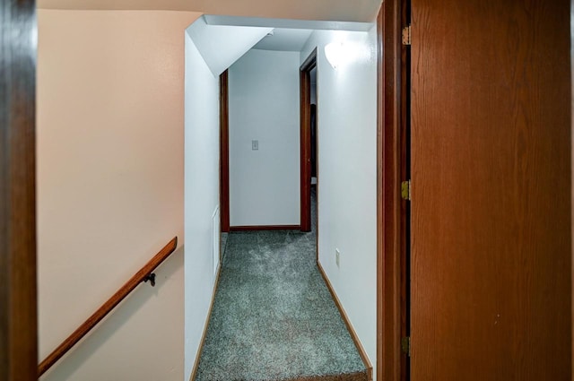 hallway with dark colored carpet