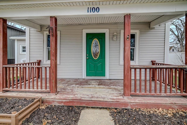 view of exterior entry with covered porch