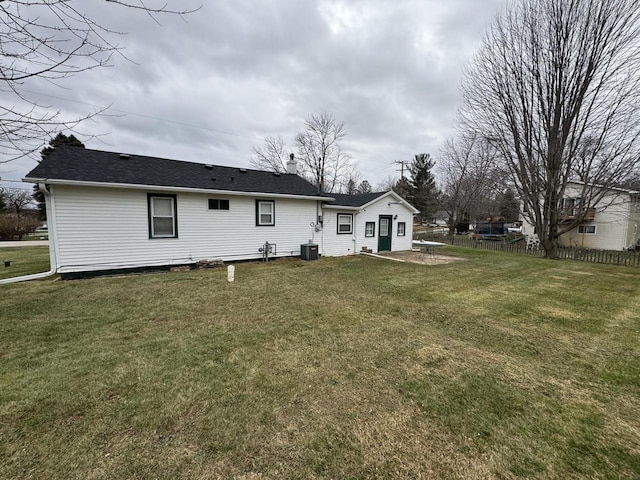 rear view of house featuring a yard, a patio, and central AC