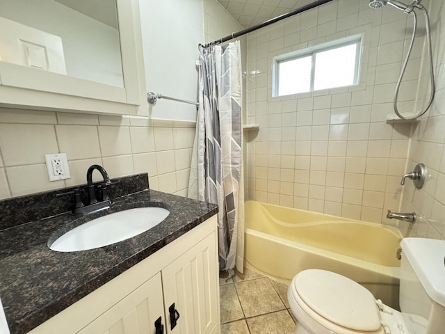 full bathroom with tile patterned floors, vanity, shower / bathtub combination with curtain, tile walls, and toilet