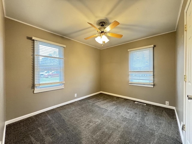 carpeted empty room featuring ceiling fan and crown molding