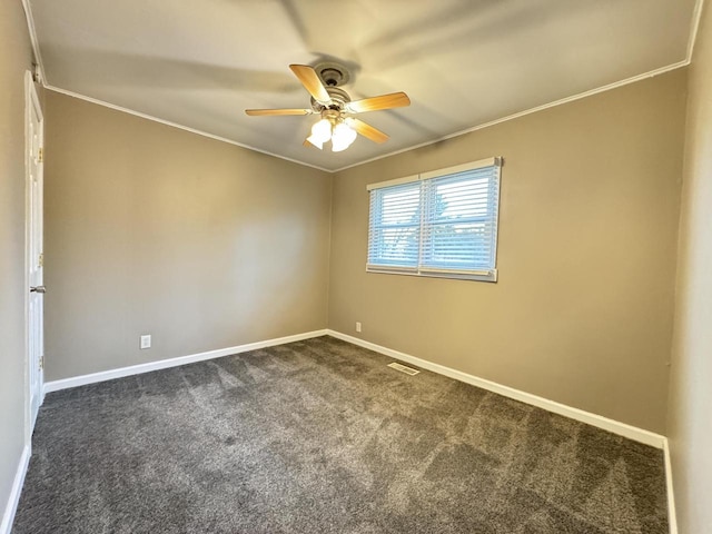 carpeted spare room featuring ceiling fan and ornamental molding