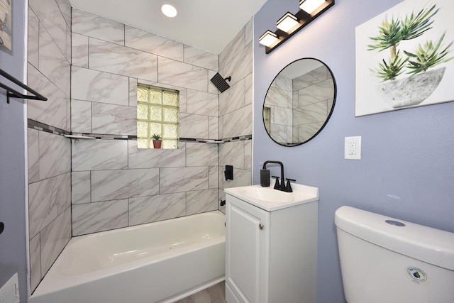 full bathroom with vanity, toilet, and tiled shower / bath