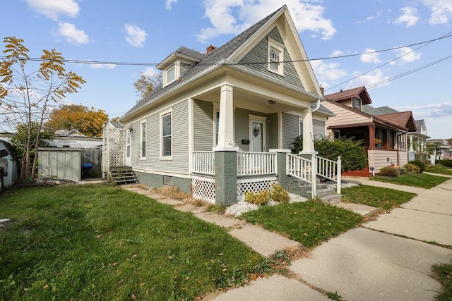 view of front of house with a front yard and a porch