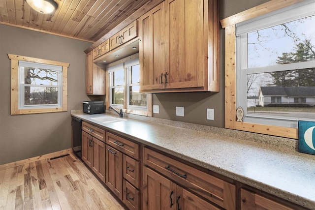 kitchen with wood ceiling, crown molding, sink, black dishwasher, and light hardwood / wood-style floors