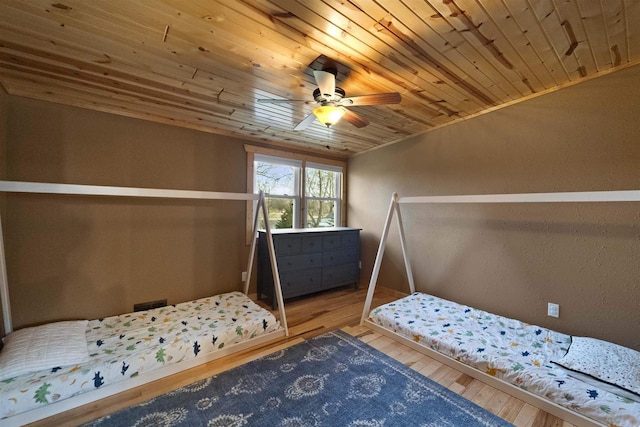 unfurnished bedroom featuring wood-type flooring, crown molding, ceiling fan, and wooden ceiling