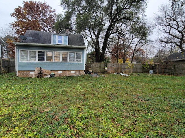 rear view of property featuring a yard