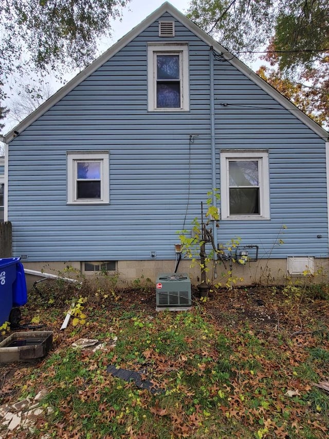 view of side of home with central air condition unit