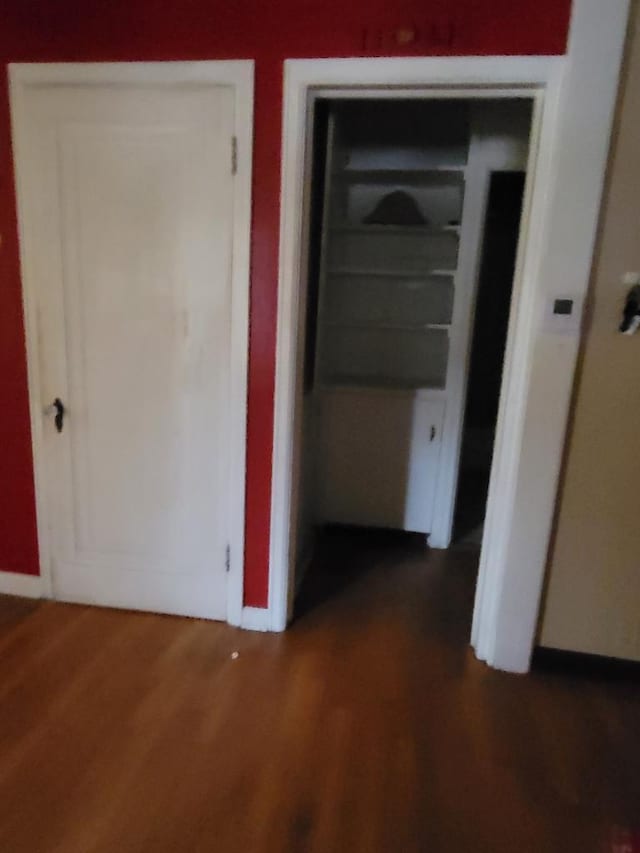 hallway with dark wood-type flooring