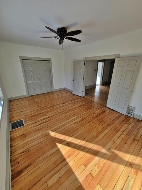 interior space with a closet, light hardwood / wood-style floors, and ceiling fan