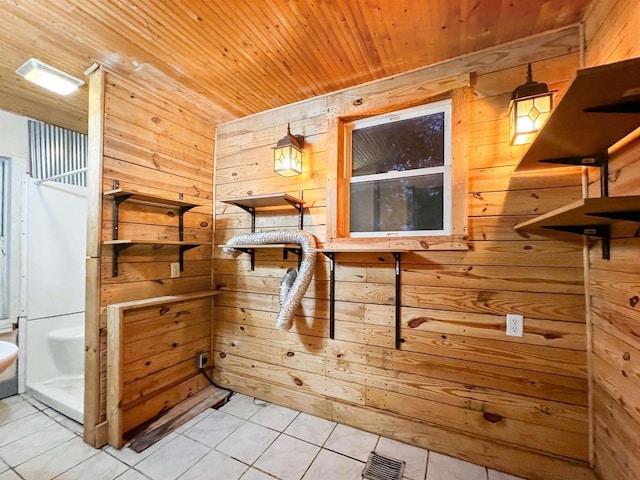 bathroom featuring tile patterned floors, wood ceiling, and wood walls