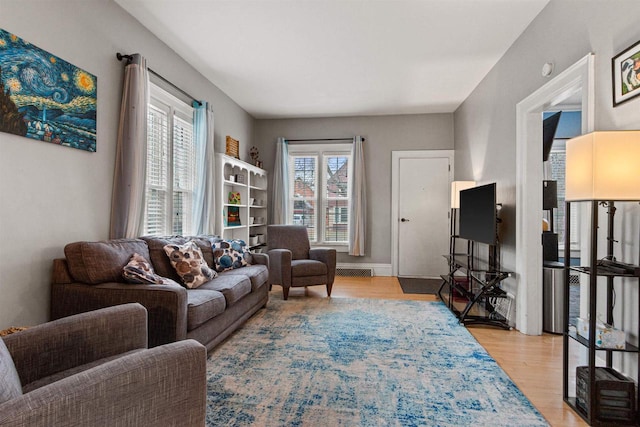 living room with plenty of natural light and light wood-type flooring