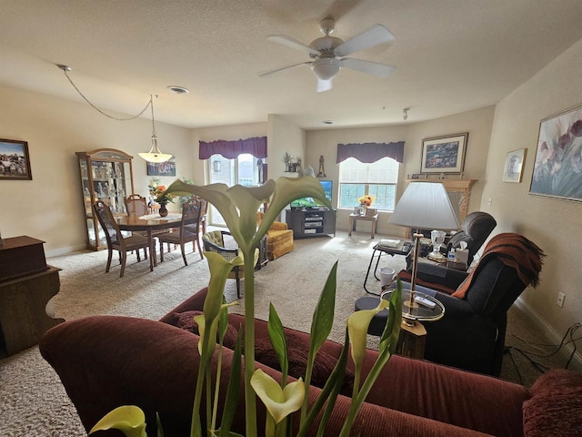 living room featuring light carpet and ceiling fan