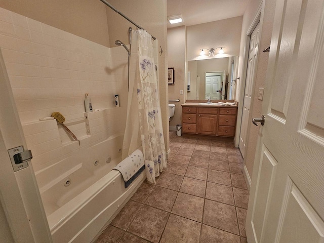 bathroom featuring tile patterned floors, shower / bath combo with shower curtain, and vanity