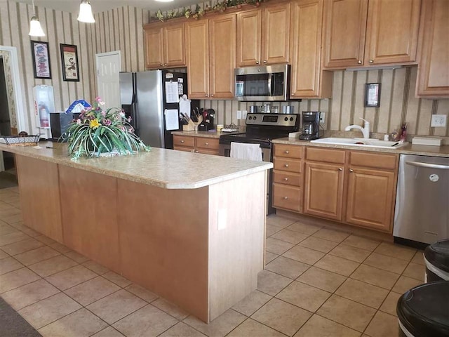 kitchen featuring light tile patterned flooring, sink, hanging light fixtures, a kitchen island, and stainless steel appliances