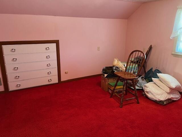 living area featuring carpet flooring and vaulted ceiling