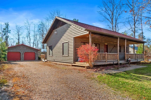 view of front of property with an outbuilding, a garage, and covered porch