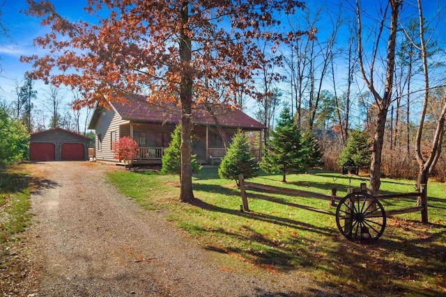 view of front of house featuring a porch, a garage, an outdoor structure, and a front yard