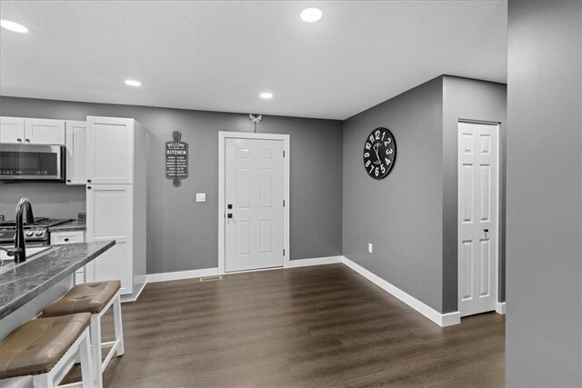 entryway featuring a textured ceiling and dark hardwood / wood-style flooring