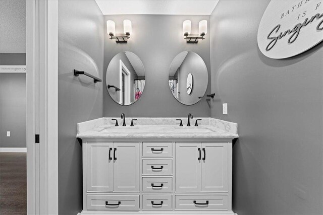 bathroom with vanity and wood-type flooring