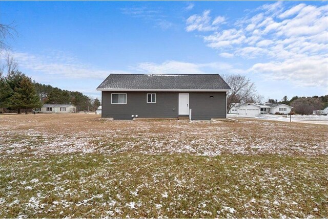 view of snow covered back of property