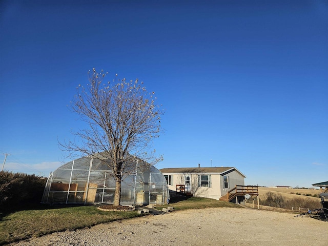 back of house featuring an outbuilding