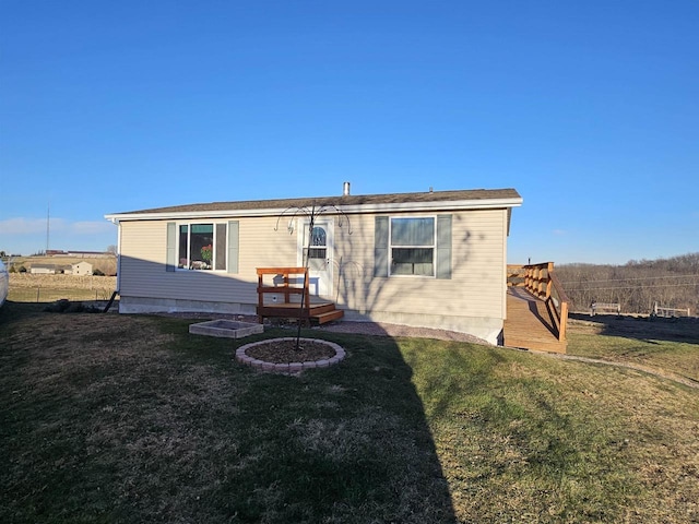 rear view of house featuring a yard