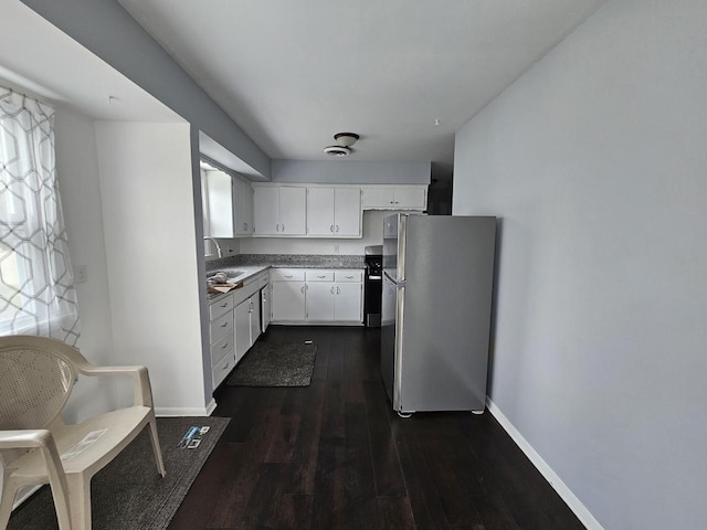 kitchen featuring white cabinetry, stainless steel fridge, plenty of natural light, and dark hardwood / wood-style floors