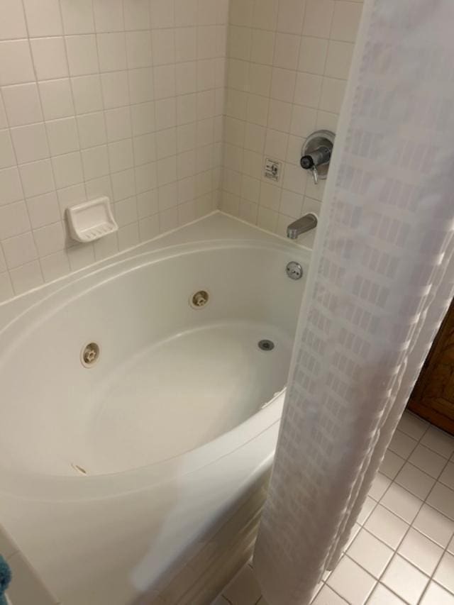 bathroom featuring tile patterned floors and shower / bath combo with shower curtain