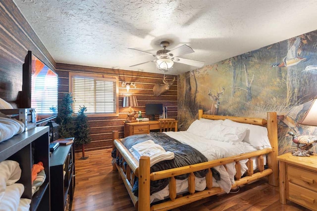 bedroom with ceiling fan, dark hardwood / wood-style floors, and a textured ceiling