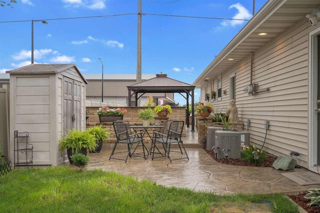 view of patio / terrace with a gazebo, central AC unit, and a storage unit