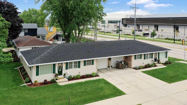 ranch-style home with a garage and a front lawn