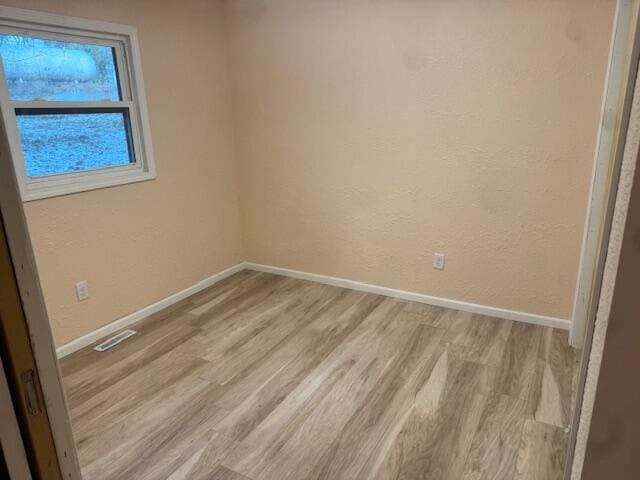 spare room featuring light wood-type flooring