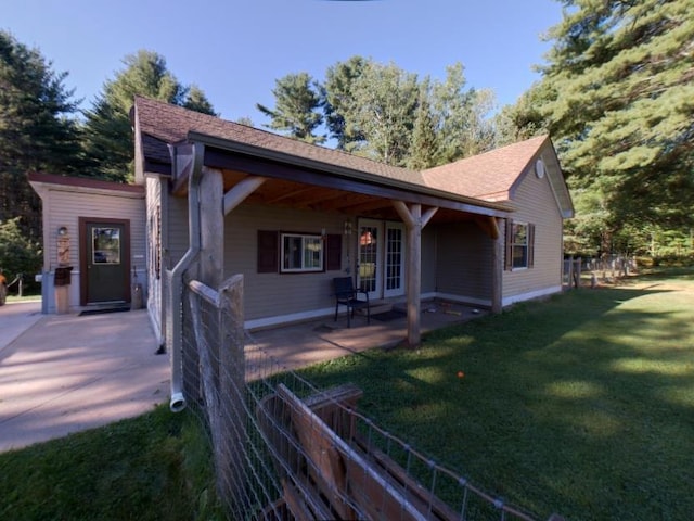 view of front of home with a front lawn and a patio area