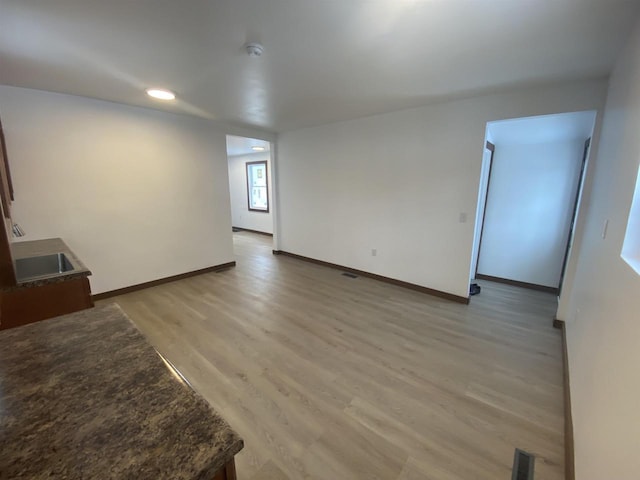 empty room with light hardwood / wood-style flooring