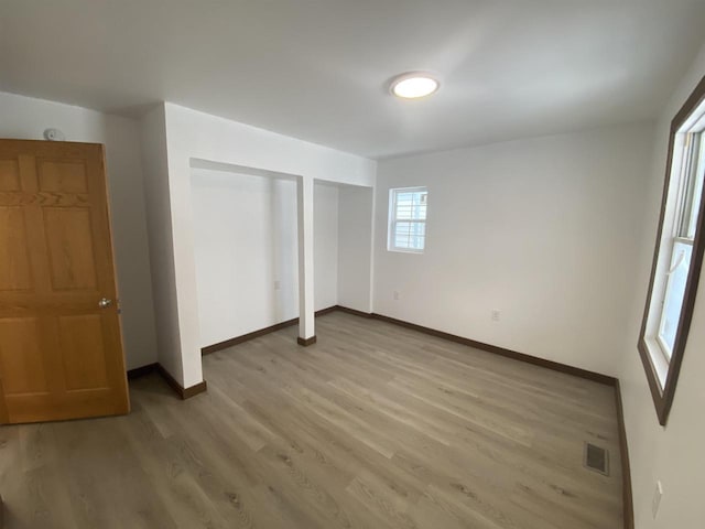 unfurnished bedroom with hardwood / wood-style flooring