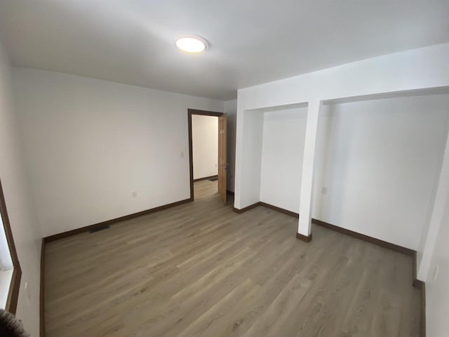 unfurnished bedroom featuring wood-type flooring