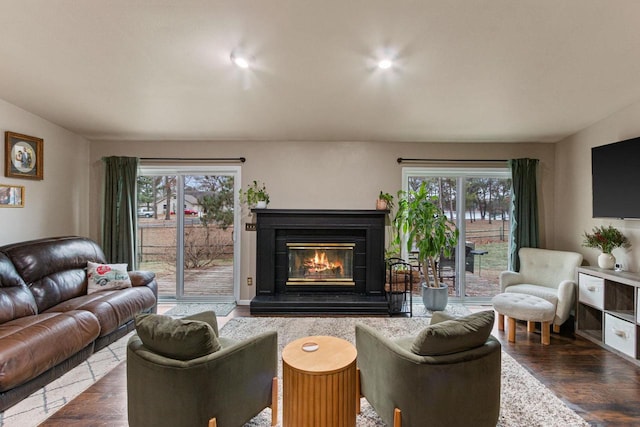 living room featuring a healthy amount of sunlight and dark hardwood / wood-style flooring