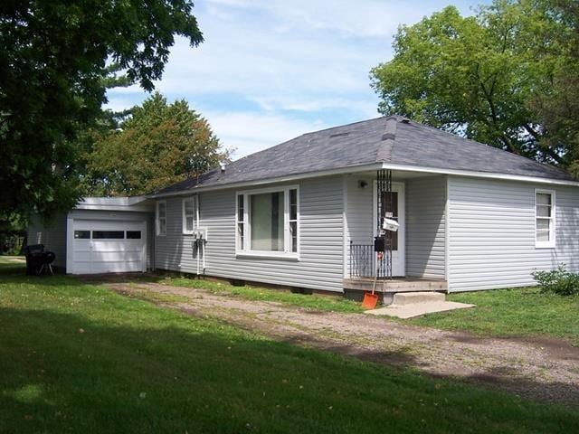 view of front of house with a front yard and a garage