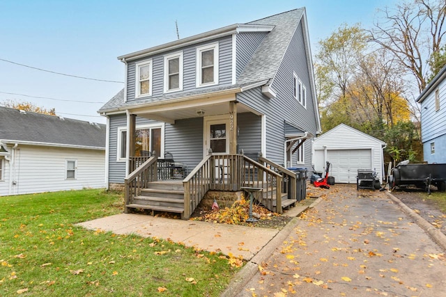 view of front facade with an outbuilding, a front lawn, and a garage