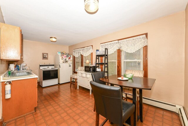 dining space with a baseboard radiator