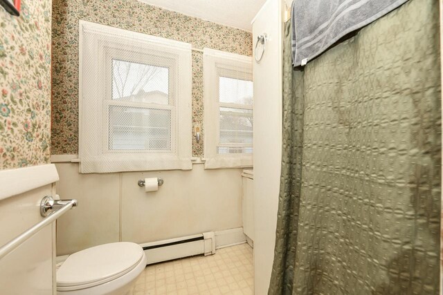 bathroom featuring toilet and baseboard heating