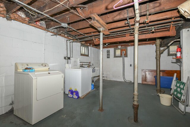 basement with washing machine and dryer and sink