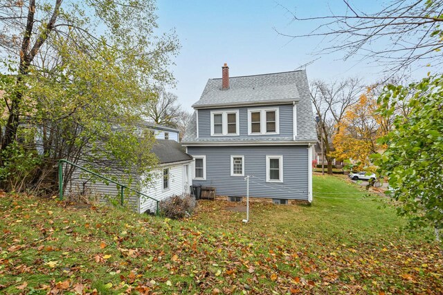 rear view of house featuring a yard