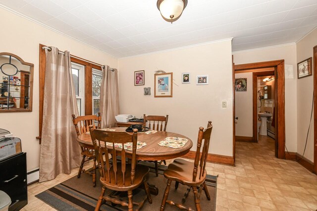 dining space with ornamental molding and a baseboard radiator