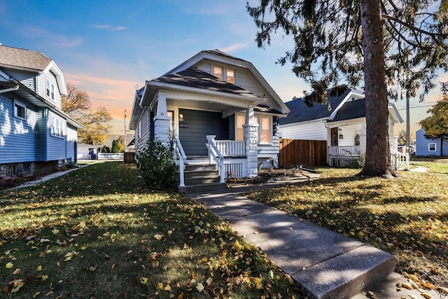 bungalow featuring a lawn and a porch