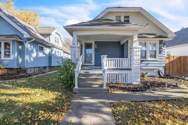 bungalow-style home with a porch and a front lawn